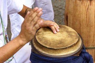Hands playing traditional African atabaque drums being played on the streets of Brazil during