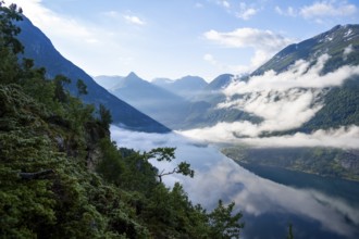View over the Geirangerfjord, atmospheric clouds over the fjord in the morning light, Ørnesvingen