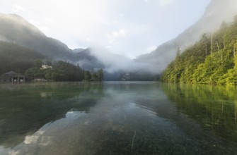 Mystical morning at Königssee in Schönau with boathouses and Christlieger. Sunrise and beautiful