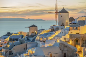 Windmills evening mood illuminated Oia Santorini Greece