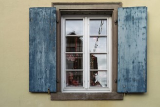 Window with blue shutters and reflections, Alsace, France