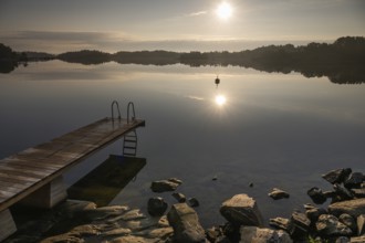 Wooden jetty with ladder, calm water surface, morning atmosphere, Kasnäsintie, Falkö Fjord, Kasnäs,