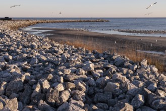 Rock jetty for erosion control contains the tidal waters of the Mississippi Sound along the