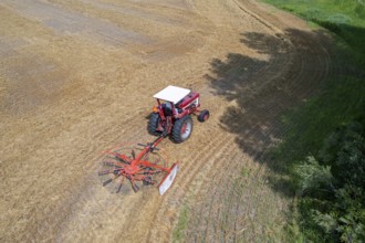 Wayland, Michigan - A farmer uses a rotary tedder to aerate his crop. A tedder spreads out hay or