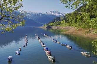 Motorboats moored at the reservoir, snow-covered Alps in the background, Lake Wägital, Canton