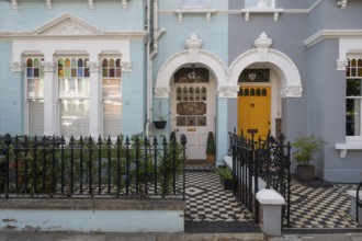 Victorian entrances, yellow door, black and white tile pattern, Kensington, London, England, Great