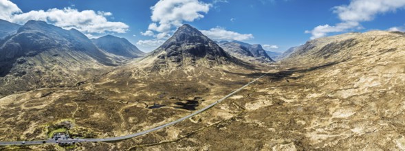 Panorama of Buachaille Etive Beag and Three Sisters in Glencoe over Moors and Road A82 from a