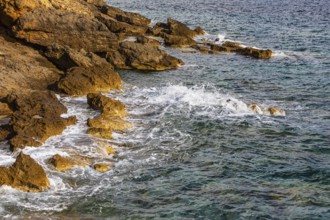 Rugged rocky coastline and foaming spray, on Stecci beach, near Capoliveri, Elba Island, Tuscan