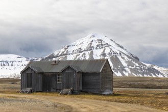 Wooden house against a mountain backdrop, Ny-Alesund, Spitsbergen, Svalbard