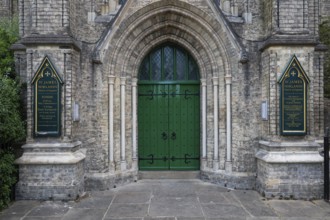 Neo-Gothic church entrance with green door, St James's Church, Norlands, architects Lewis Vulliamy,