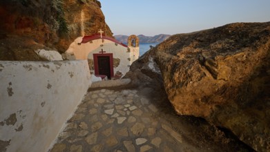 Legend, crab, shell fisherman, stone path to the chapel on the coast, surrounded by rocks, with