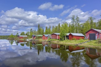 Traditional red wooden boat houses, boathouses at Lake Ånnsjön, Jämtland County, western Sweden,