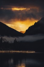 Surreal light atmosphere at sunrise at Plansee, Tyrol, in the Alps in Austria