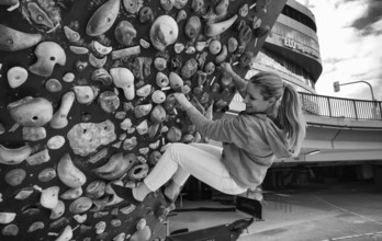 Woman, blonde, 40 years, climbing on climbing wall, urban, concrete, black and white, Stuttgart,