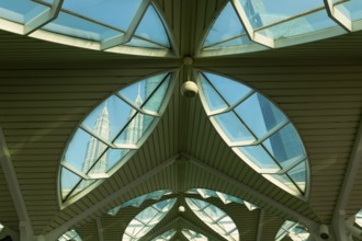 Petronas twin towers viewed through glass roofs of As Syakirin Mosque or KLCC Mosque, Kuala Lumpur,