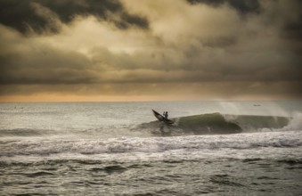 Fisherman in a traditional dugout canoe in the surf of the Indian Ocean on the east coast of
