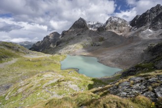 View of the turquoise-blue mountain lake Großer Gradensee, with the peaks of Petzeck and
