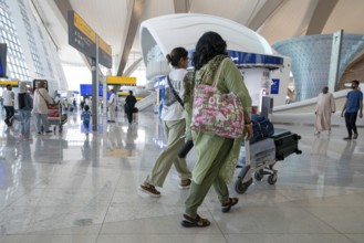 Airport Women with luggage, Abu Dhabi, United Arab Emirates