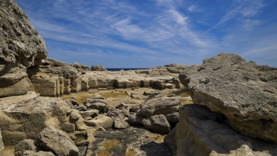 Expansive rocky landscape under a blue sky, Oasis Beach, east coast of Rhodes, Rhodes, Dodecanese,