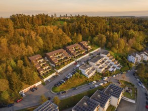 Overview of housing estate on a hill, surrounded by trees, warm sunlight, Nagold, Black Forest,