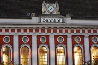Hamm main station, façade with station clock and sculptures of a wire-drawer and a miner at the