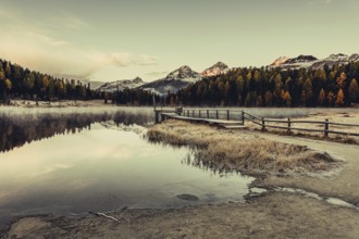 Lake Staz near Sankt Moritz in the Engadin in Switzerland. Morning atmosphere with fog in autumn.