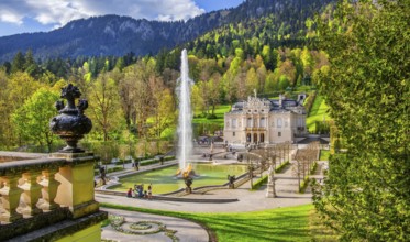 Water parterre with large fountain and portal of Linderhof Castle in spring, municipality of Ettal,