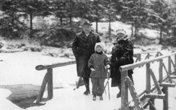 Winter excursion, 1930s, Three people in winter clothing stand on a snow-covered bridge in front of