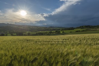 Dramatic cloudy sky with approaching storm and last sunbeams, Frankenhain, dark cloud wall,
