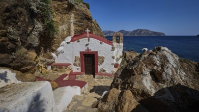 Legend, crab, shell fisherman, Mediterranean chapel with red roof on the rocky coast overlooking