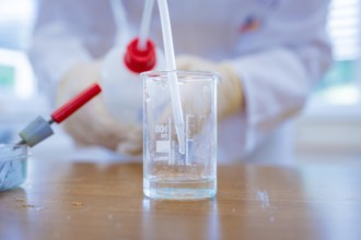 Close-up of a beaker with liquid and pipette in the laboratory, Battery Research, Nagold, Germany