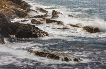 Rugged rocky coastline and foaming spray, on Stecci beach, near Capoliveri, Elba Island, Tuscan