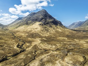 Buachaille Etive Beag and Three Sisters in Glencoe over Moors and Road A82 from a drone, Highlands,