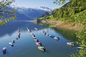 Motorboats moored at the reservoir, snow-covered Alps in the background, Lake Wägital, Canton
