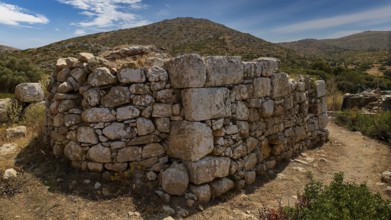 Sky exchanged, Large stone wall in an unspoilt mountain landscape with cloudy sky and surrounded by
