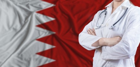 Doctor with crossed arms on Bahrain flag. Bahrain health and care concept. Female doctor on Bahrain