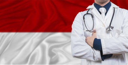 Male doctor with stethoscope on Monaco flag. Doctor holding stethoscope on Monaco flag