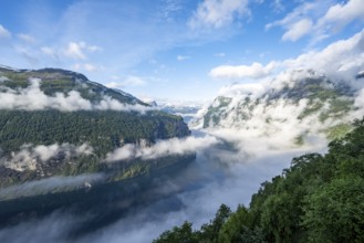 View over the Geirangerfjord, atmospheric clouds over the fjord in the morning light, Ørnesvingen