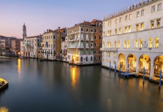 View of the Grand Canal at sunset, picturesque evening mood with illuminated palazzos on the canal