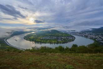 View of a river bend, surrounded by green hills and a cloudy sky. morning atmosphere, summer, Rhine