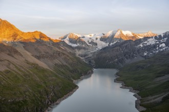 View at the summit of Mont de la Blana, alpenglow at sunset, view of a blue mountain lake, Lac des