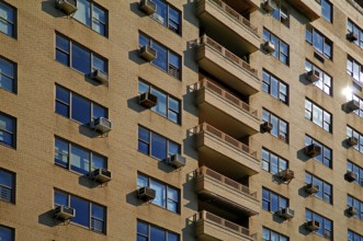 Brick façade of a high-rise building with air conditioning for the flats, New York City, USA