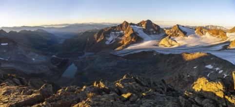 Picturesque high mountain landscape at sunrise with alpenglow, blue glacial lakes, glaciers and