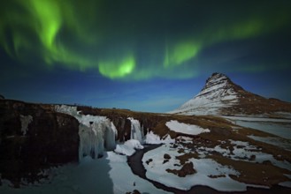Aurora Borealis from Iceland. Beautiful green Northern Lights on the dark blue night sky with peak