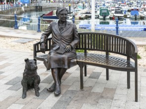 Bronze sculpture statue artwork Agatha Christie sitting on bench with her dog, Torquay, Devon,