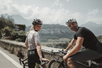 Woman and man cycling on Lake Garda in Italy. Sunny weather and dolce vita