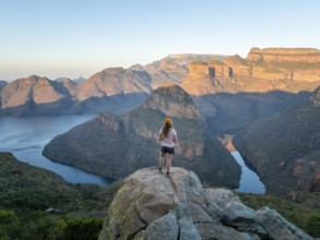 Hiker enjoying panorama, Blyde River Canyon with summit Three Rondawels, view of canyon with river