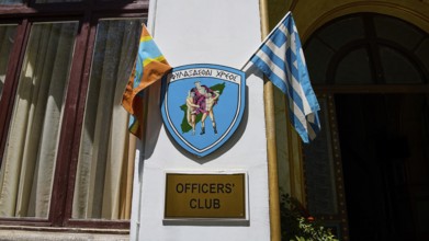 Building with sign of the officers' club, Greek flag and coat of arms, harbour area, Rhodes Town,