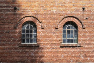 Old windows in a traditional brick wall with rustic charm and visible reflections, Stiftsmühle,