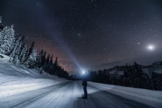 Starry sky during a winter road trip on the Icefields Parkway with lots of snow and ice, Banff